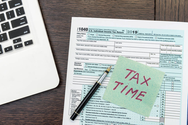 Financial time tax form with laptop and calculator. Office paperwork. Accounting - Photo, image