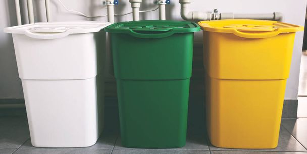 Three colorful trash cans for sorting garbage. For plastic, glass and paper - Foto, afbeelding
