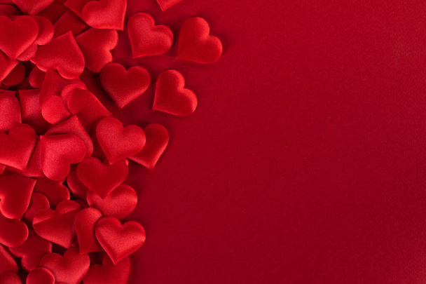 Valentine's day many red silk hearts on paper background, love concept - Foto, Imagem