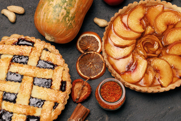 Berry tart pie and apple tart pie on black background - 写真・画像