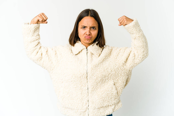 Young mixed race woman showing strength gesture with arms, symbol of power - Photo, Image