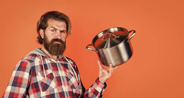 Need some help. housekeep husband cook in pot. mature chef in checkered shirt. prepare meal food at home. professional cook. bearded man hold kitchen pan. brutal hipster cooking with saucepan - Zdjęcie, obraz