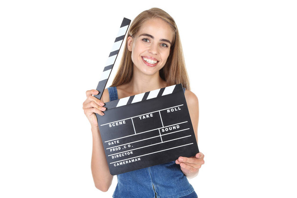 Beautiful girl with clapperboard on white background - Fotoğraf, Görsel