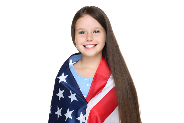 Young girl wrapped in american flag on white background - 写真・画像