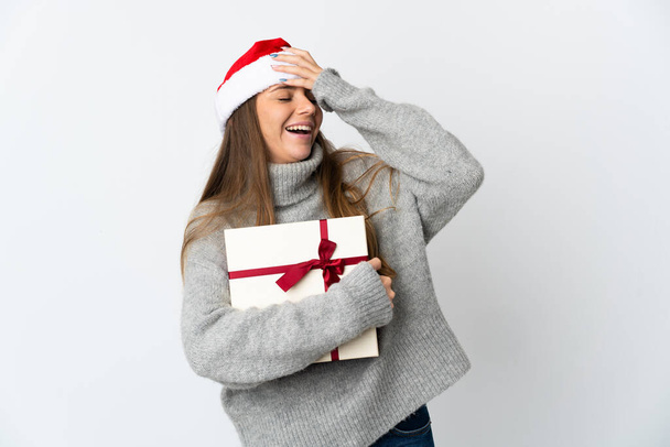 Lithianian woman with christmas hat holding presents isolated on white background smiling a lot - Photo, Image