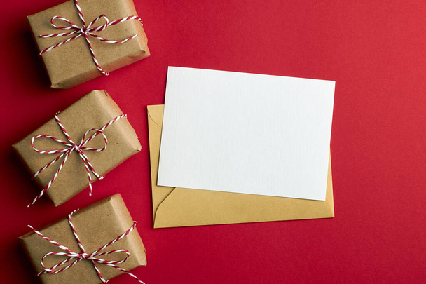 Greeting card mockup with gift boxes on red - 写真・画像