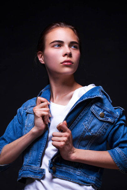 Portrait of a young beautiful brunette model in jeans jacket - Foto, imagen