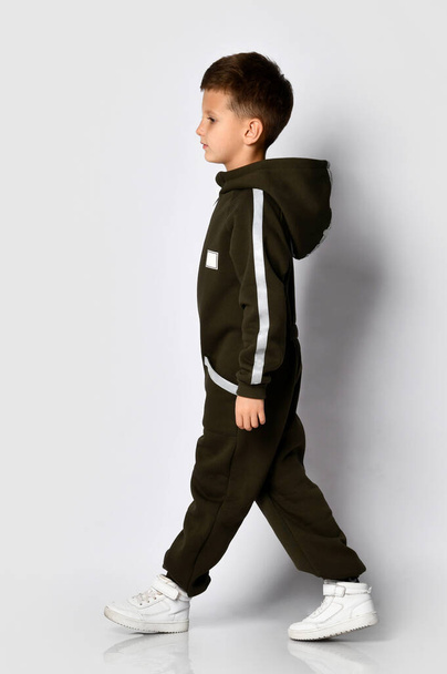 Boy wearing black warm jumpsuit in motion shot - Foto, imagen