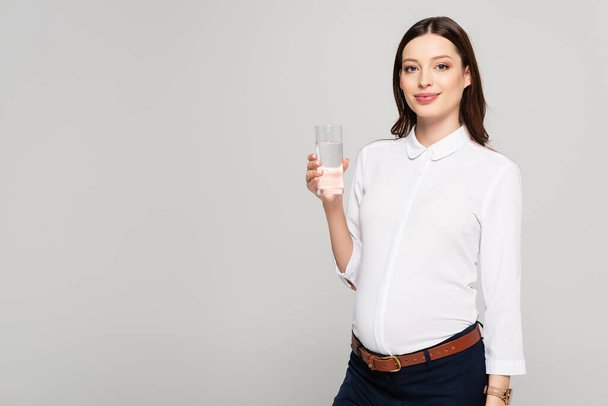 young pregnant businesswoman with glass of water isolated on grey - Φωτογραφία, εικόνα