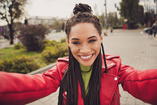 Photo of young afro woman happy positive smile make self photo selfie shooting blogger wear leather jacket - Foto, afbeelding
