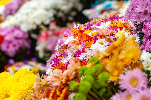 Colourful bouquet of blooming flowers in outdoor market. Typical atmosphere of flower store - Фото, зображення