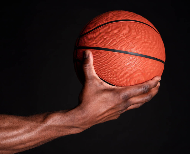 black man hand holds basketball ball - Photo, Image