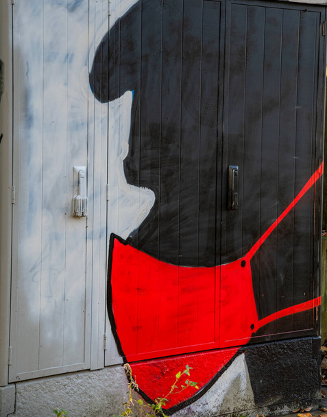 Ilustración de una cara en negro con protector bucal en rojo - Foto, imagen