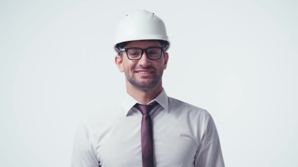 happy architect in hardhat and glasses greeting isolated on white - Footage, Video