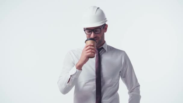architect in hardhat drinking coffee to go isolated on white - Footage, Video
