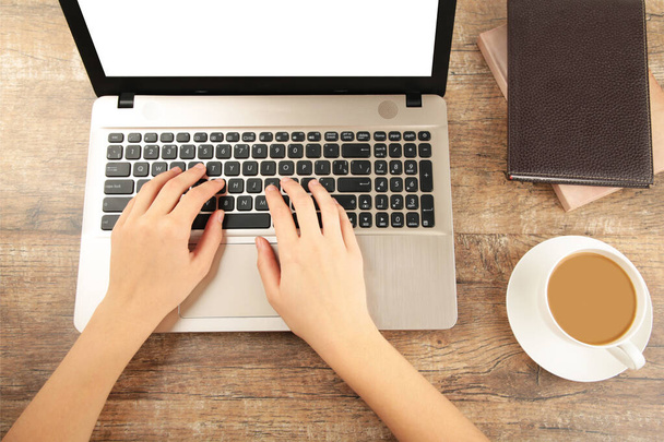 Female hands working on modern laptop. Office desktop on brown background. - Fotografie, Obrázek