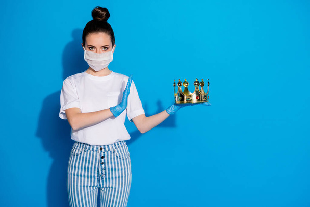 Portrait of her she nice attractive serious confident girl holding in hands gold crown deny ban stop anti against virus isolated on bright vivid shine vibrant blue color background - Foto, Imagen