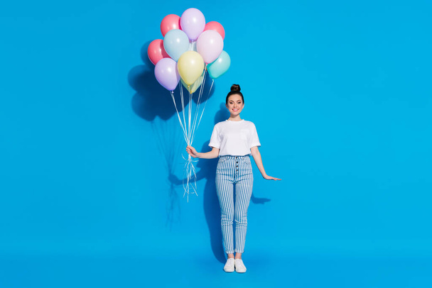 Full length body size view of nice attractive lovely charming pretty cheerful cheery girl holding in hands bunch decorative air balls isolated on bright vivid sine vibrant blue color background - Foto, Imagem