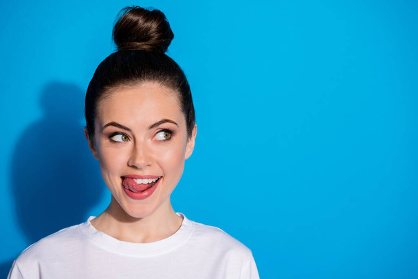 Close-up portrait of her she nice attractive pretty lovely cute girlish funky playful cheerful cheery girl licking lip counting calories isolated on bright vivid sine vibrant blue color background - Foto, Imagen