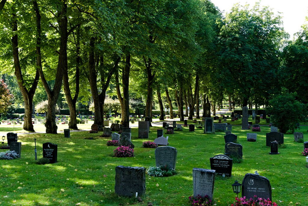 Oslo, Norway - Aug 29th: Nordre cemetery with headstones and tall old trees.  - Photo, Image