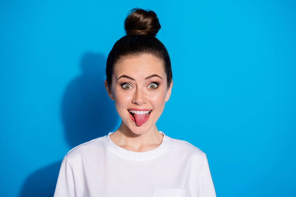 Close-up portrait of her she nice attractive pretty funky comic playful naughty cheerful cheery girl showing tongue out good crazy mood isolated on bright vivid sine vibrant blue color background - Fotografie, Obrázek