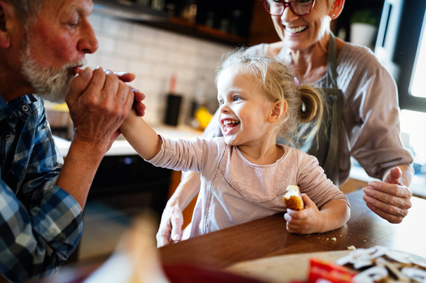 Happy grandparents playing and having fun with their granddaughter - 写真・画像