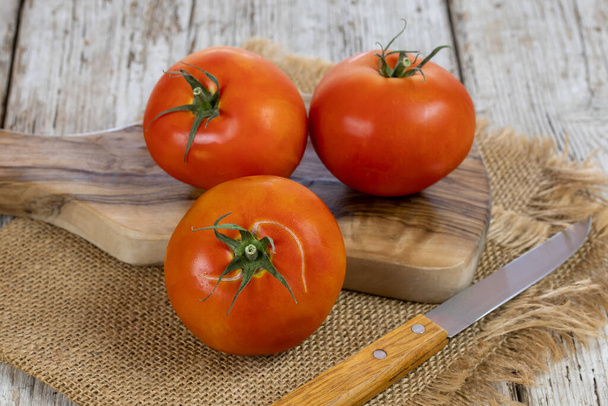 fresh tomatoes on wooden table  - 写真・画像