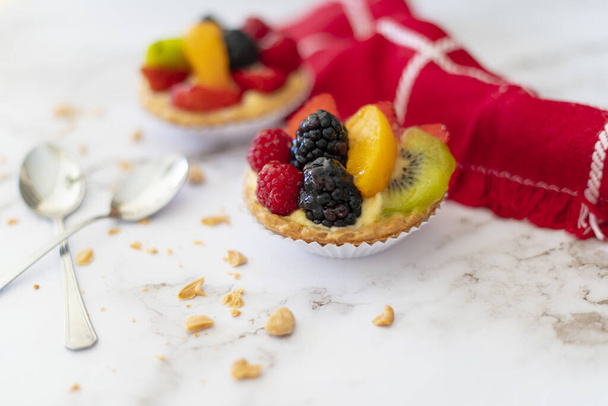 A closeup shot of delicious desserts with fresh fruits - Фото, зображення