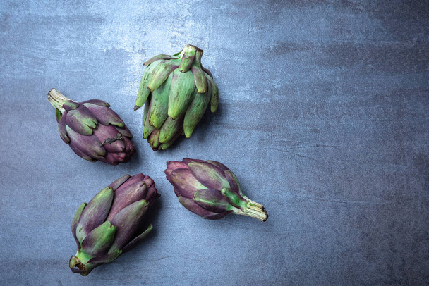 Fresh Italian artichokes on gray background, seen from above, free area for editions - Photo, Image