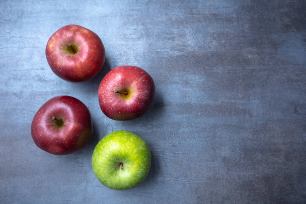 red and green apples on a gray stone background. View from the top. Free space. - Photo, Image