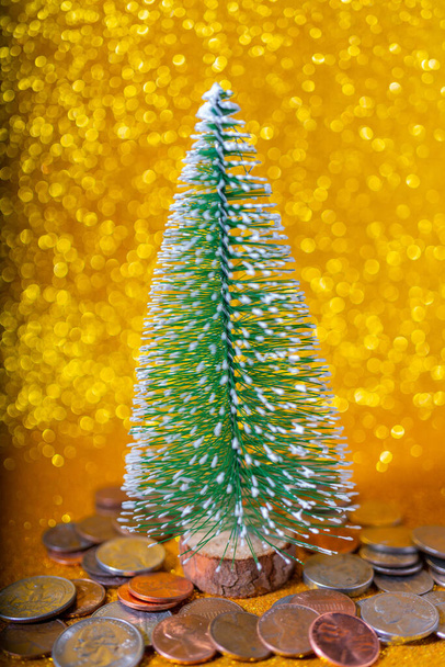christmas tree with coins on golden background  - Fotoğraf, Görsel