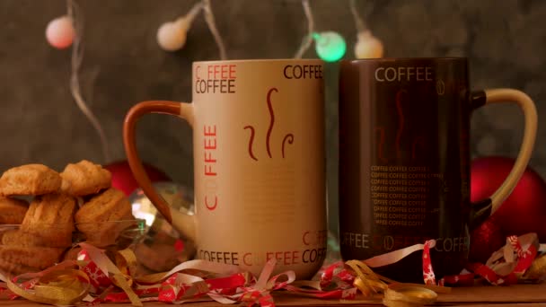 Christmas coffee cups with bokeh lights decoration. Winter holidays music background, cozy home good morning concept, New year festive song. Two mugs with hot tea drink. Love romance couple date. - Footage, Video