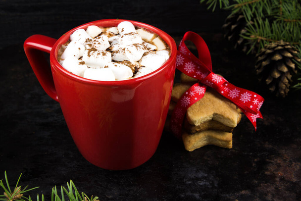 A mug of hot cocoa with marshmallows on a dark background - Foto, imagen