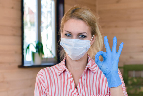 woman in medical mask and gloves. symptoms of coronavirus. - Fotó, kép