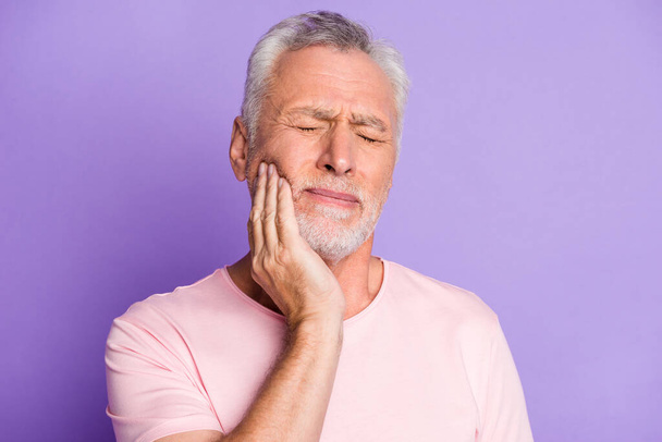 Close-up portrait of his he nice attractive sick grey-haired man touching cheek jaw feeling tooth pain caries isolated over bright vivid shine vibrant lilac purple violet color background - Foto, afbeelding