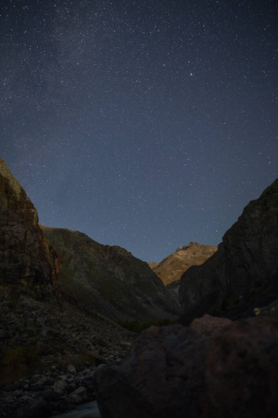 Starry sky against the background of the Caucasus mountains - Photo, image