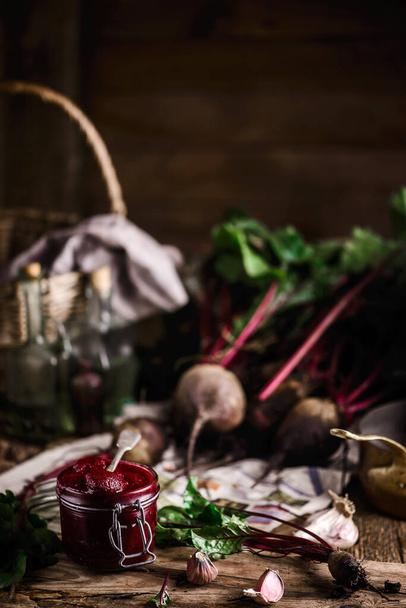 Homemade beet ketchup in a glass jar. Rustic style.selective focus - Photo, Image