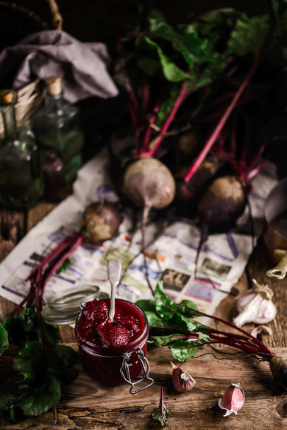 Homemade beet ketchup in a glass jar. Rustic style.selective focus - Foto, imagen