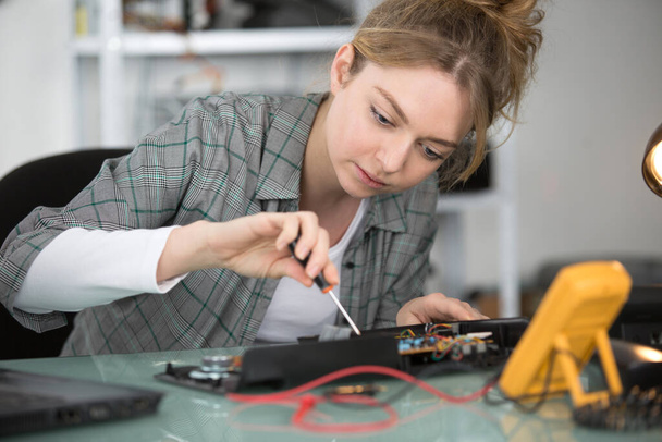 woman repairing computer part in service center - Photo, image