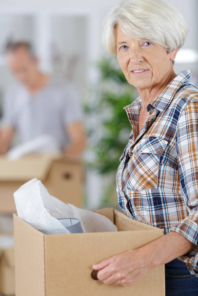 senior woman cheerful and calm holding a box - Foto, imagen