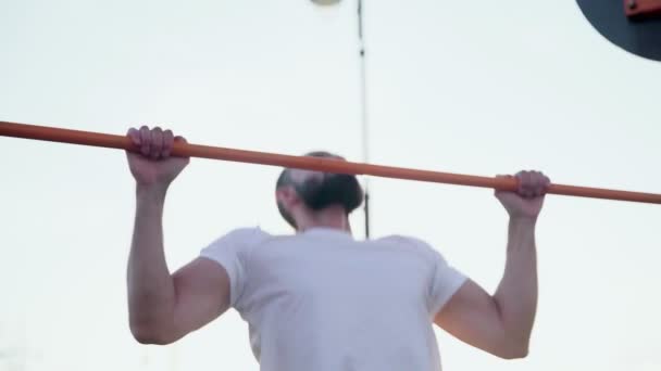 Close up de homem musculoso fazendo pull-ups na barra horizontal. Na área de treino perto de casa - Filmagem, Vídeo