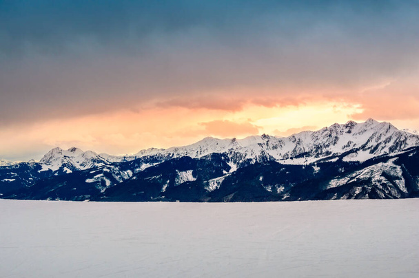 Zell am See in winter. View from Schmittenhohe, snowy slope of ski resort in the Alps mountains, Austria. Stunning landscape with mountain range, snow and sunset sky near Kaprun - Photo, image