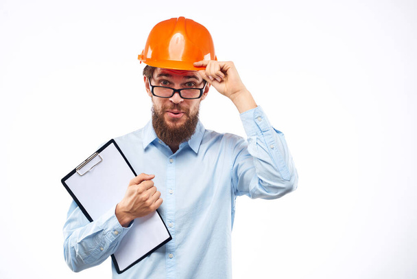 A man in orange paint in glasses documents a manual industry - Φωτογραφία, εικόνα
