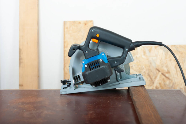 Electric hand tool circular saw on desk, on background oriented strand board - Photo, Image
