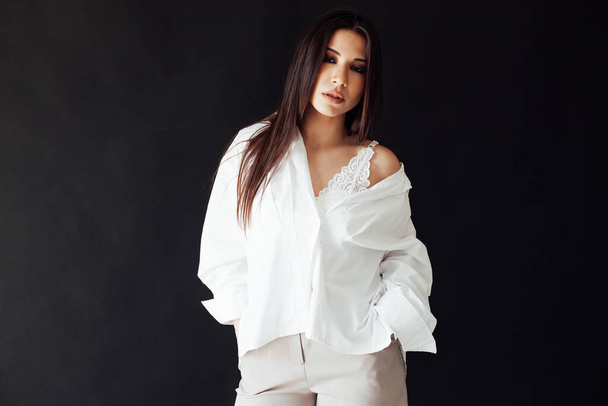 Beautiful fashionable brunette woman in light white mens silk shirt - Foto, immagini