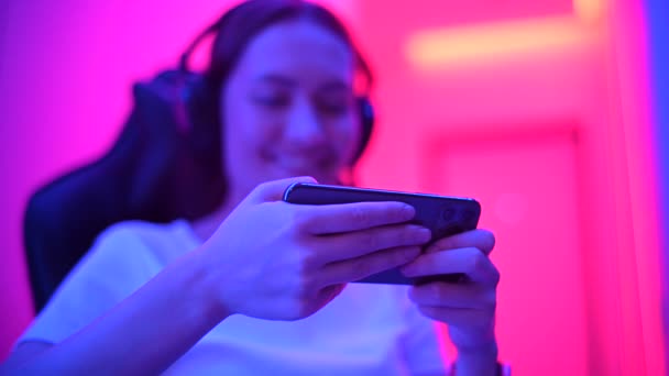 Closeup of teenage girl gamer hands holding smart phone playing online video game. Cyber sports mobile gaming by 5g smartphone on esports tournament. - Footage, Video