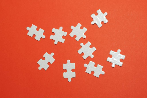 pieces of jigsaw puzzle on the red background - Photo, Image