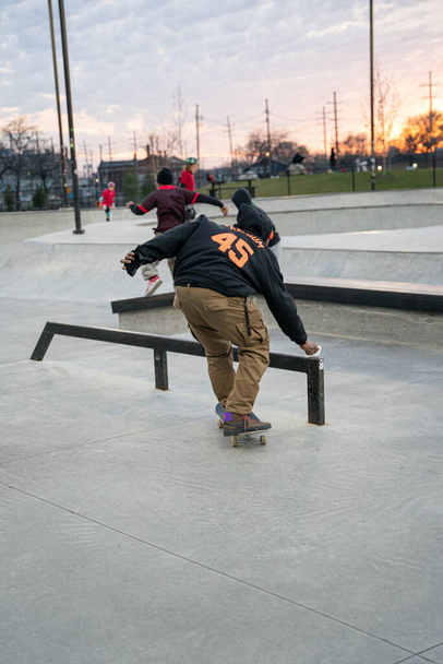 skaters and bikers practice tricks at an outdoor skate park in Detroit, Michigan / USA - November 19 -2020 - Фото, зображення