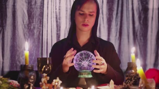 Male fortune teller performing ritual with crystal ball foreseeing future - Footage, Video