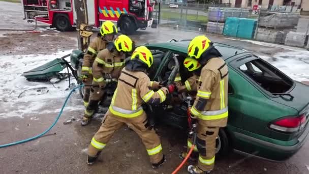 Firefighter cutting car doors with hydraulic cutter. Car accident - Footage, Video